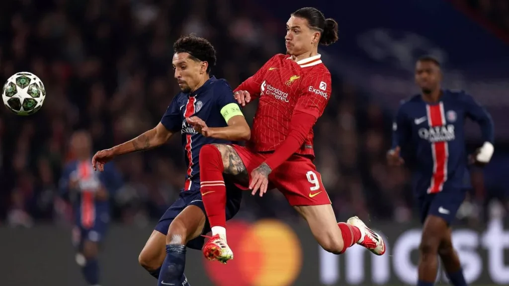 Liverpool players look dejected as PSG celebrates their victory in a tense penalty shootout at Anfield, sealing the Reds' elimination from the UEFA Champions League