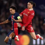 Liverpool players look dejected as PSG celebrates their victory in a tense penalty shootout at Anfield, sealing the Reds' elimination from the UEFA Champions League